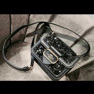 Coach Black Crossbody Bag with Structured Design and Metallic Accents